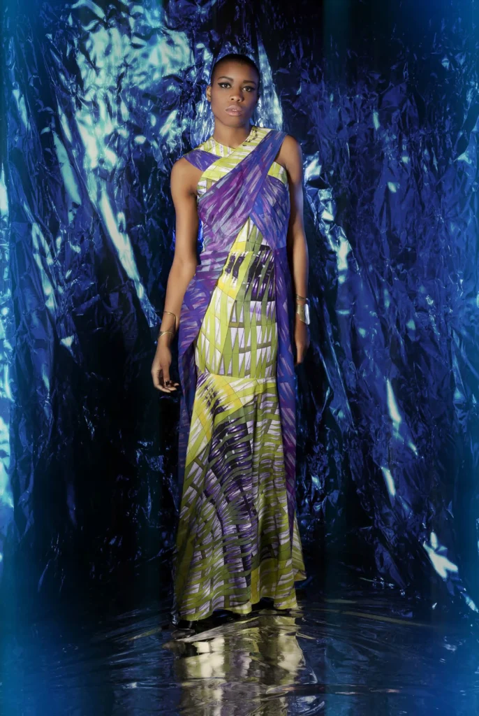 Dress in crinkle chiffon and habutai silk, pleated at the waist and shoulders in shades of blue, purple, and green.